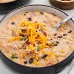 Crack chicken chili in a bowl topped with shredded cheese.