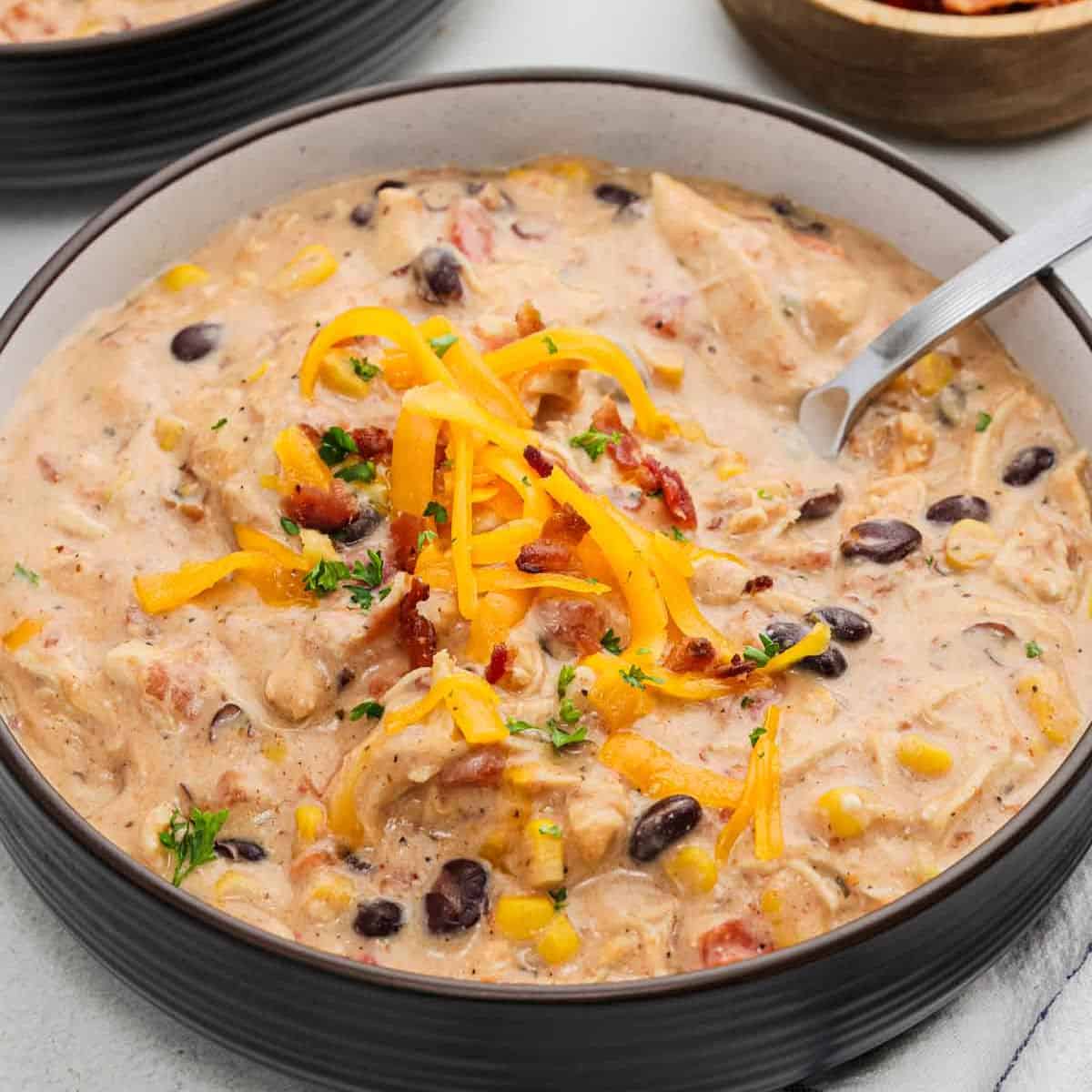 Crack chicken chili in a bowl topped with shredded cheese.