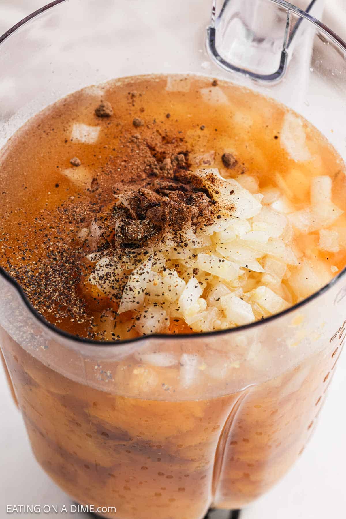 Spices, onion and roasted squash in a blender.