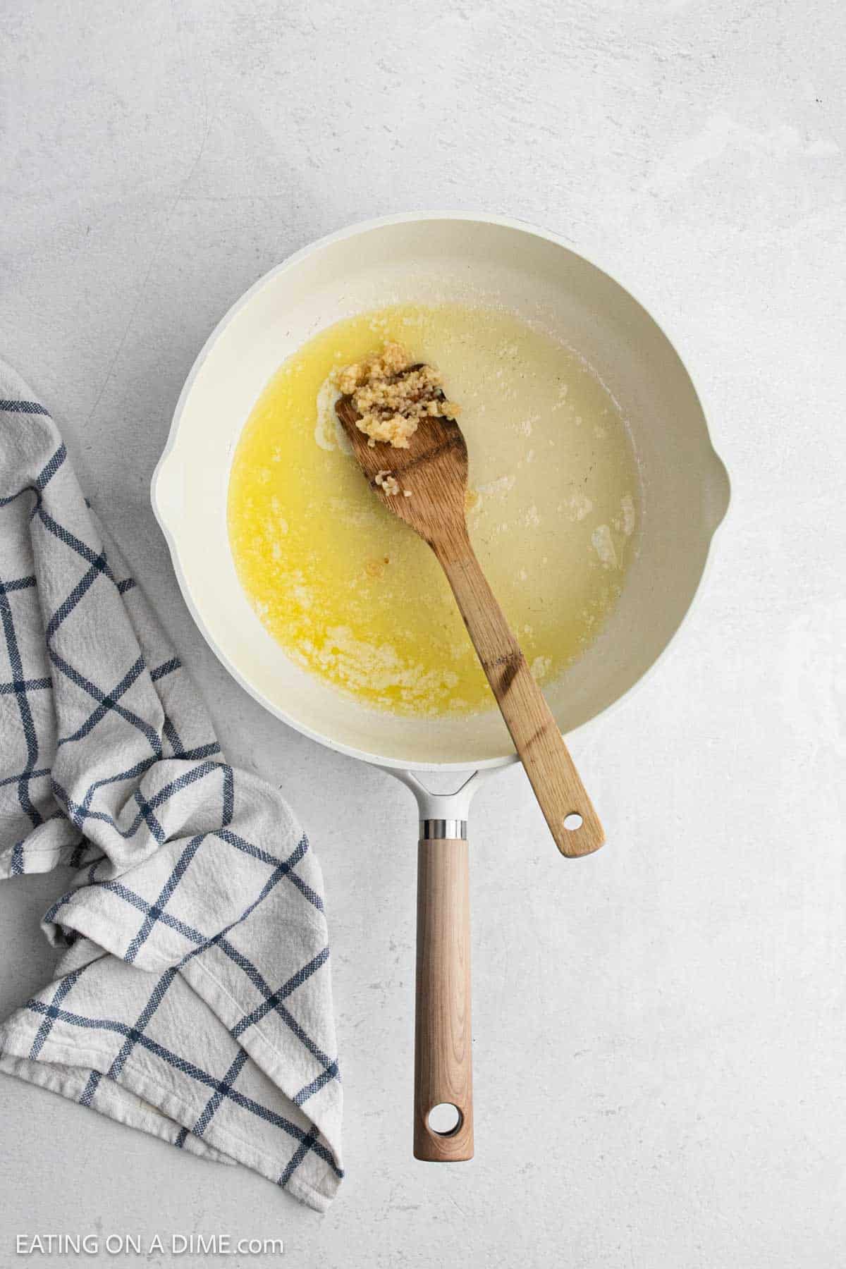 Melted butter and minced garlic in a skillet.