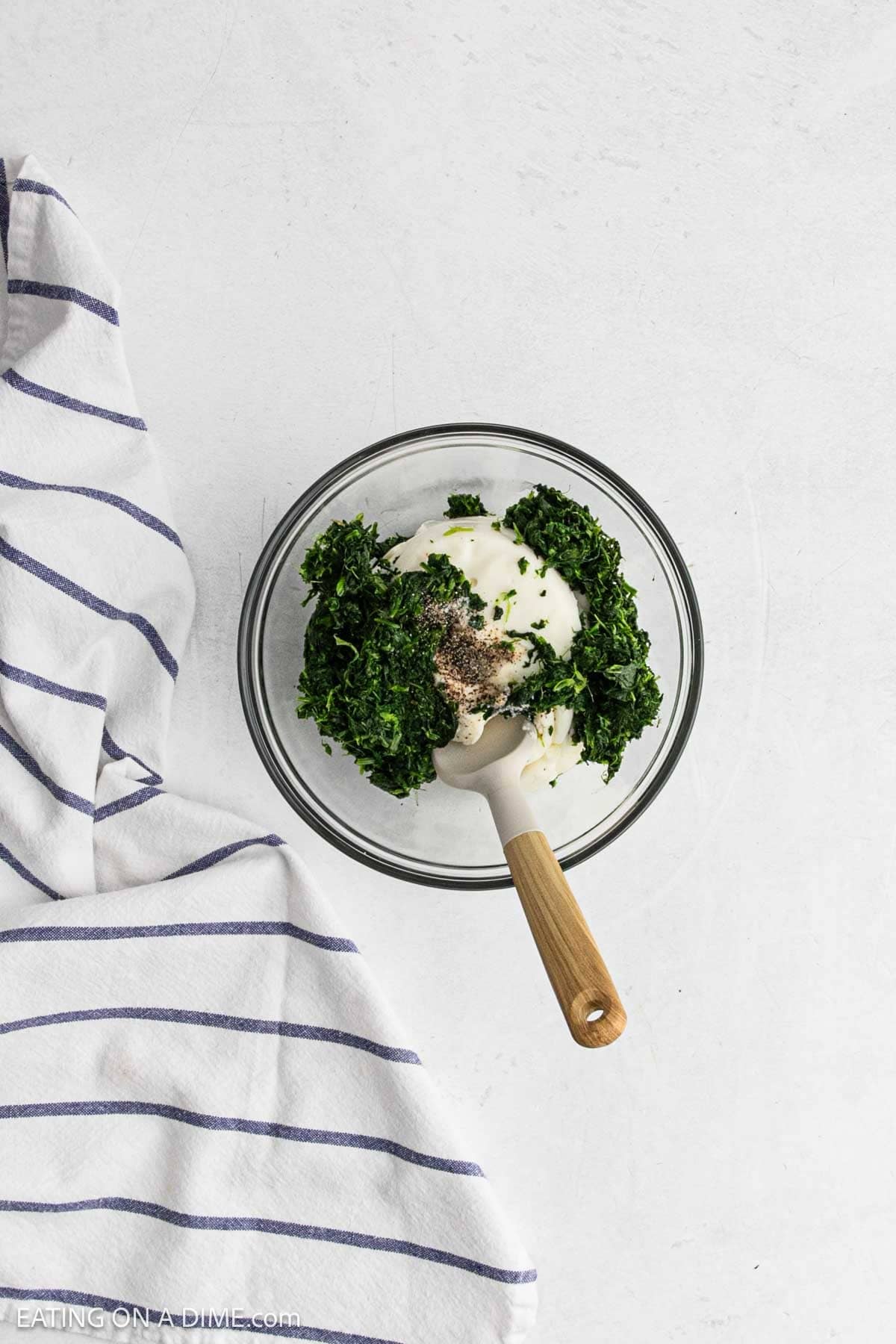 Ricotta cheese, spinach, salt and black in a bowl.