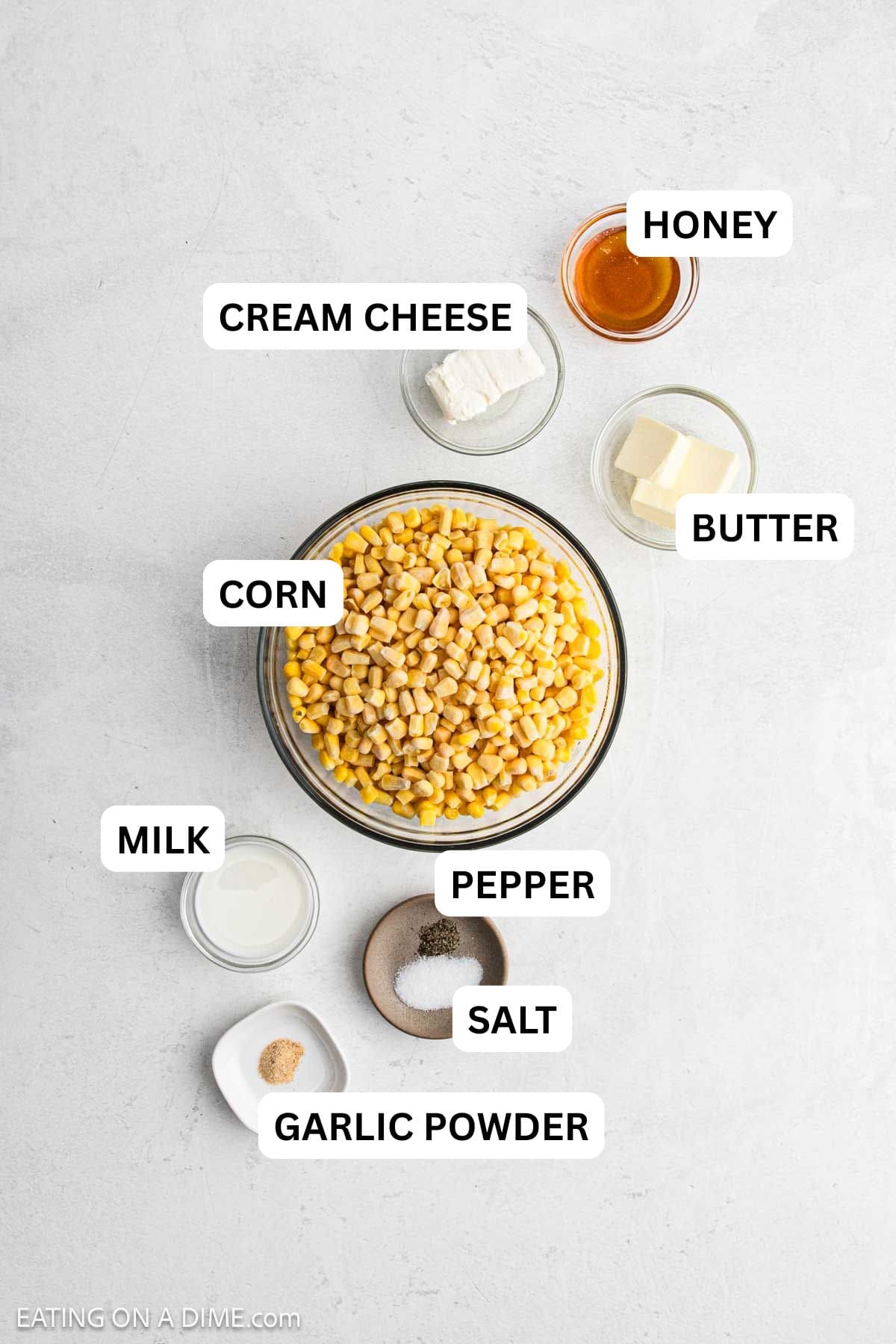 Ingredients needed for this recipe includes corn, butter, honey, cream cheese, salt, pepper, milk, and garlic powder.