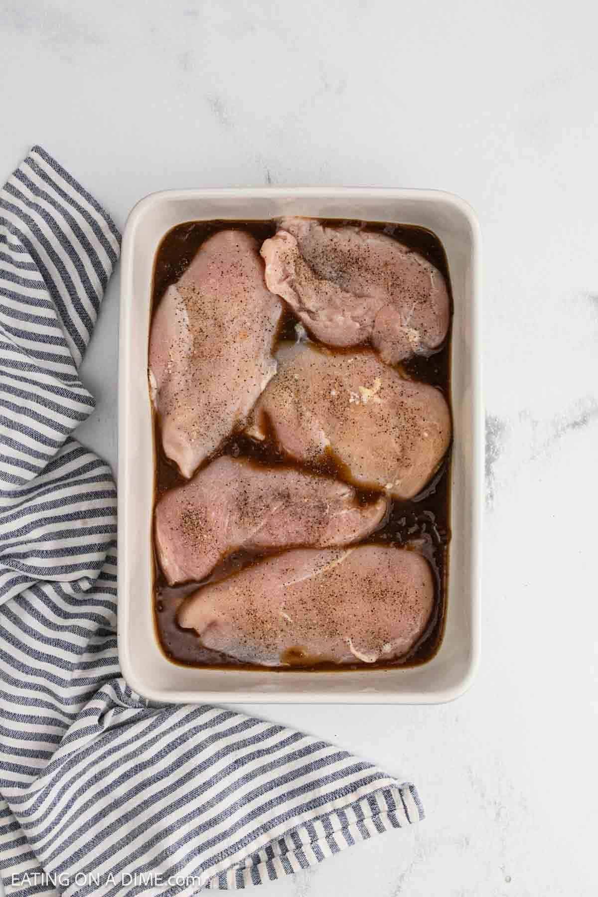 Seasoning added to the chicken breasts in the baking dish.