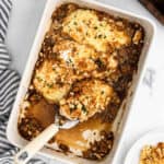 French Onion Chicken Bake in a baking dish and a serving on the spatula.